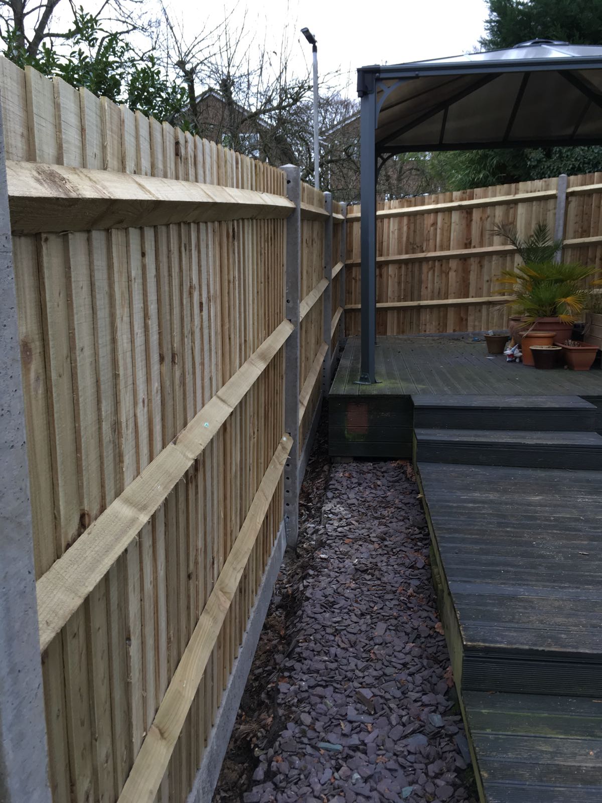 Close-up of feather edge boarding and concrete post